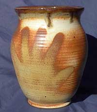 handprint art on thrown vessel