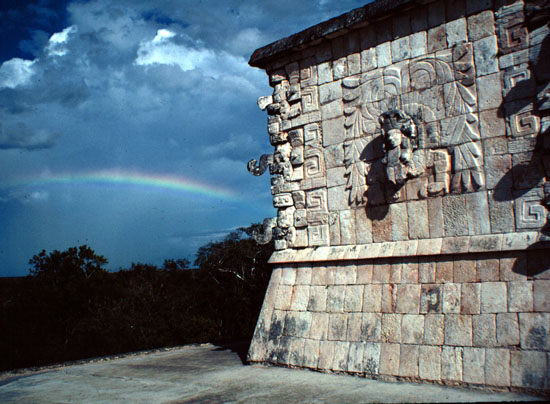 chichen Itza facade with rainbow and chac masks.