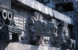 Feathered Serpent and Tlaloc masks project from the facade of the Quetzalcoatl Pyramid.